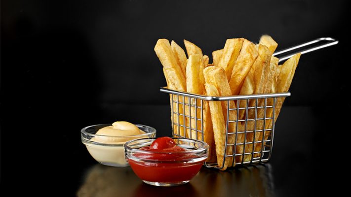 Stock Photo French Fries In Basket With Ketchup And Sauce Isolated On Black Background Front View 708617422